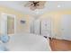 Cozy bedroom features wood floors and an armoire, with a glimpse into an en suite bathroom at 213 South Myrtle Dr., Surfside Beach, SC 29575