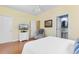 Comfortable bedroom boasts hardwood floors, a ceiling fan, and a view into the en suite bathroom at 213 South Myrtle Dr., Surfside Beach, SC 29575