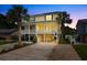 Stunning elevated beach house features a spacious covered parking area and charming double-decker porch, perfect for coastal living at 213 South Myrtle Dr., Surfside Beach, SC 29575