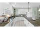 Well-lit kitchen with white cabinetry, granite counters, and stainless steel appliances provides ample space for cooking and storage at 213 South Myrtle Dr., Surfside Beach, SC 29575