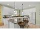 Bright, open kitchen with white cabinets, granite countertops, a central island, and pendant lighting for a modern touch at 213 South Myrtle Dr., Surfside Beach, SC 29575