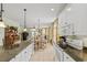 Open-concept kitchen flows into a dining area, featuring white cabinets, granite counters, and stylish accents at 213 South Myrtle Dr., Surfside Beach, SC 29575
