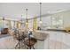 Spacious kitchen boasts an island with seating, white cabinetry, granite countertops, and an open layout for entertaining at 213 South Myrtle Dr., Surfside Beach, SC 29575