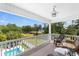 Spacious outdoor deck with seating, a ceiling fan, and views of the pool and backyard at 213 South Myrtle Dr., Surfside Beach, SC 29575