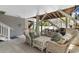 Inviting outdoor patio with comfortable wicker seating and staircase leading to upper level at 213 South Myrtle Dr., Surfside Beach, SC 29575