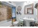 Well-maintained bathroom featuring a shower-tub combo with tile surround, pedestal sink, and decorative mirror at 223 Maison Dr. # B-8, Myrtle Beach, SC 29572