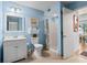 Charming bathroom features a shower, vanity, and toilet, enhanced by coastal-themed decor and blue walls at 223 Maison Dr. # B-8, Myrtle Beach, SC 29572