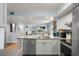 Bright kitchen features stainless appliances, island with sink, and open floor plan to living and dining spaces at 223 Maison Dr. # B-8, Myrtle Beach, SC 29572