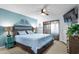 Comfortable main bedroom with ceiling fan, dresser, TV, and sliding door to screened porch at 223 Maison Dr. # B-8, Myrtle Beach, SC 29572