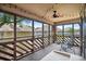 Relaxing screened porch with ceiling fan, string lights, and outdoor furniture to enjoy the outdoors at 223 Maison Dr. # B-8, Myrtle Beach, SC 29572