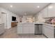Well-lit kitchen featuring granite counters, stainless steel dishwasher and ample cabinet storage at 226 Carver Willow Dr., Loris, SC 29569