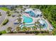Aerial view of the community pool and lazy river, showing ample parking and nearby amenities at 229 Coral Beach Circle, Surfside Beach, SC 29575