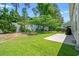 Well-maintained backyard with mature trees offers a private outdoor space at 229 Coral Beach Circle, Surfside Beach, SC 29575