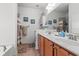 Bright bathroom with dual sinks, wood cabinets, and large mirrors with modern lighting at 229 Coral Beach Circle, Surfside Beach, SC 29575