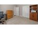 Spacious bedroom featuring a closet, shelving, and a wooden dresser with natural light at 229 Coral Beach Circle, Surfside Beach, SC 29575