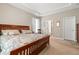 Well-lit bedroom featuring a wooden bed frame, side tables, and ensuite bath access at 229 Coral Beach Circle, Surfside Beach, SC 29575