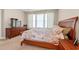 Well-lit bedroom featuring a dresser, side tables, and bright windows at 229 Coral Beach Circle, Surfside Beach, SC 29575