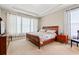 Comfortable bedroom featuring a wooden bed frame, side tables, and bright windows at 229 Coral Beach Circle, Surfside Beach, SC 29575