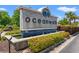 The 'Oceanwalk' welcome sign is surrounded by landscaping, making a great first impression for homeowners and their guests at 229 Coral Beach Circle, Surfside Beach, SC 29575