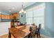 Bright dining area showcasing a wooden table, a window with a view, and seamless flow to the kitchen at 229 Coral Beach Circle, Surfside Beach, SC 29575