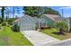 Beautiful home with mature landscaping, a manicured lawn, and an attached garage at 229 Coral Beach Circle, Surfside Beach, SC 29575