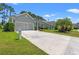 Charming home featuring an attached garage, a well-manicured lawn and mature landscaping at 229 Coral Beach Circle, Surfside Beach, SC 29575