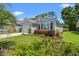 Well-maintained home with a manicured lawn and mature shrubs at 229 Coral Beach Circle, Surfside Beach, SC 29575