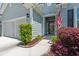 Charming front entrance featuring an American flag, decorative shrubs, and sidewalk at 229 Coral Beach Circle, Surfside Beach, SC 29575