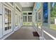 Bright sunroom featuring tiled floors, large windows, and a ceiling fan, providing a cozy space at 229 Coral Beach Circle, Surfside Beach, SC 29575