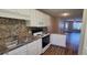 Well-lit kitchen with white cabinetry, granite countertops, and stainless-steel appliances at 2407 James St. # 401, Conway, SC 29527