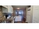 Well-equipped kitchen with white cabinets, and a view to a spacious living area at 2407 James St. # 401, Conway, SC 29527