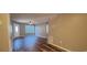Open-concept living room with neutral walls, ceiling fan, and exterior door at 2407 James St. # 401, Conway, SC 29527