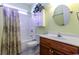 Bathroom featuring shower with curtain, wooden vanity, mirror, and bright walls at 2499 Burning Tree Ln., Little River, SC 29566