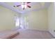 Bright main bedroom with tray ceiling and ensuite bathroom access at 2499 Burning Tree Ln., Little River, SC 29566