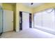 Bedroom featuring sliding closet doors, large window, neutral carpet, and pale yellow walls at 2499 Burning Tree Ln., Little River, SC 29566