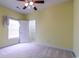 Bedroom with closet, ceiling fan, neutral carpet, pale yellow walls, and natural light at 2499 Burning Tree Ln., Little River, SC 29566