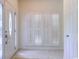 Entryway featuring leaded glass door, window with shutter, neutral carpet, and bright white walls at 2499 Burning Tree Ln., Little River, SC 29566