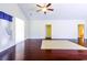 Bright and airy living room with ceiling fan and hardwood floors at 2499 Burning Tree Ln., Little River, SC 29566