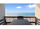 Beach view from a shaded balcony with table and chairs for outdoor relaxation at 2609 South Ocean Blvd. # 702, North Myrtle Beach, SC 29582