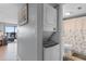 Hallway to the living room with a stacked washer and dryer plus bathroom at 2609 South Ocean Blvd. # 702, North Myrtle Beach, SC 29582