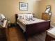 Cozy bedroom with wood laminate flooring, a sleigh bed, and vintage furniture at 266 Tall Palms Way, Little River, SC 29566
