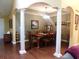 Elegant dining room with hardwood floors, decorative columns, and ample seating for guests at 266 Tall Palms Way, Little River, SC 29566