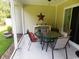 Covered patio featuring a table, chairs, and a decorative star at 266 Tall Palms Way, Little River, SC 29566