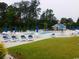 Resort style pool area with sun loungers and umbrellas for relaxing by the water at 266 Tall Palms Way, Little River, SC 29566