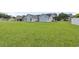 Expansive backyard view showcases the house's siding and a sprawling green lawn perfect for outdoor activities at 282 Foxpath Loop, Myrtle Beach, SC 29588