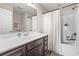 Bathroom with a dark wood vanity, white countertops, and a shower-tub combo at 282 Foxpath Loop, Myrtle Beach, SC 29588
