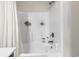 Shower and tub combination with white tile and shower curtain at 282 Foxpath Loop, Myrtle Beach, SC 29588