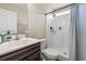 Bathroom features a vanity with sink, toilet, and shower with a blue and white striped shower curtain at 282 Foxpath Loop, Myrtle Beach, SC 29588