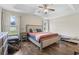Bright bedroom featuring a tray ceiling, hardwood floors, and large windows at 282 Foxpath Loop, Myrtle Beach, SC 29588