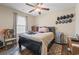 Cozy bedroom featuring a ceiling fan, a comfortable bed and a collection of caps hanging on the wall for decoration at 282 Foxpath Loop, Myrtle Beach, SC 29588